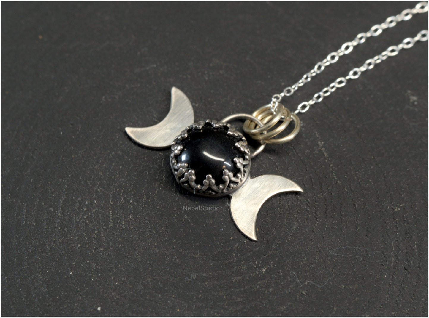 Silver triple moon pendant with gothic-styled bezel and obsidian