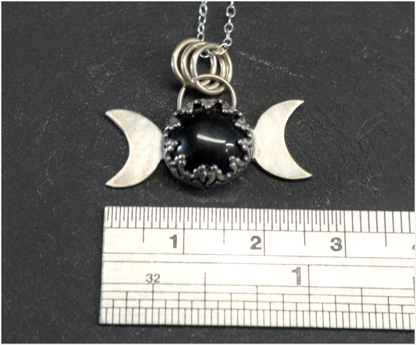 Silver triple moon pendant with gothic-styled bezel and obsidian